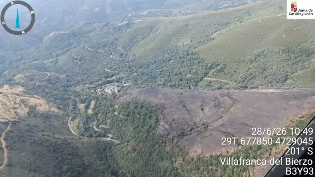 Vista aérea del incendio de Pradela en Trabadelo con zona quemada y medios de extinción trabajando en la mañana del domingo.